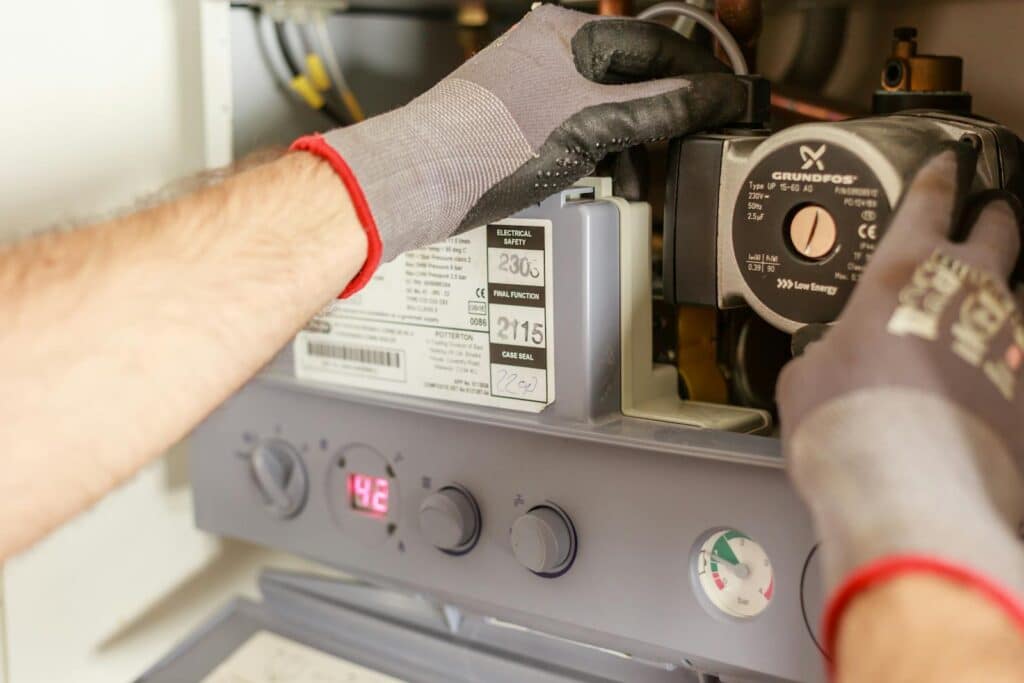 Technician repairing a residential boiler in Merrimack, NH